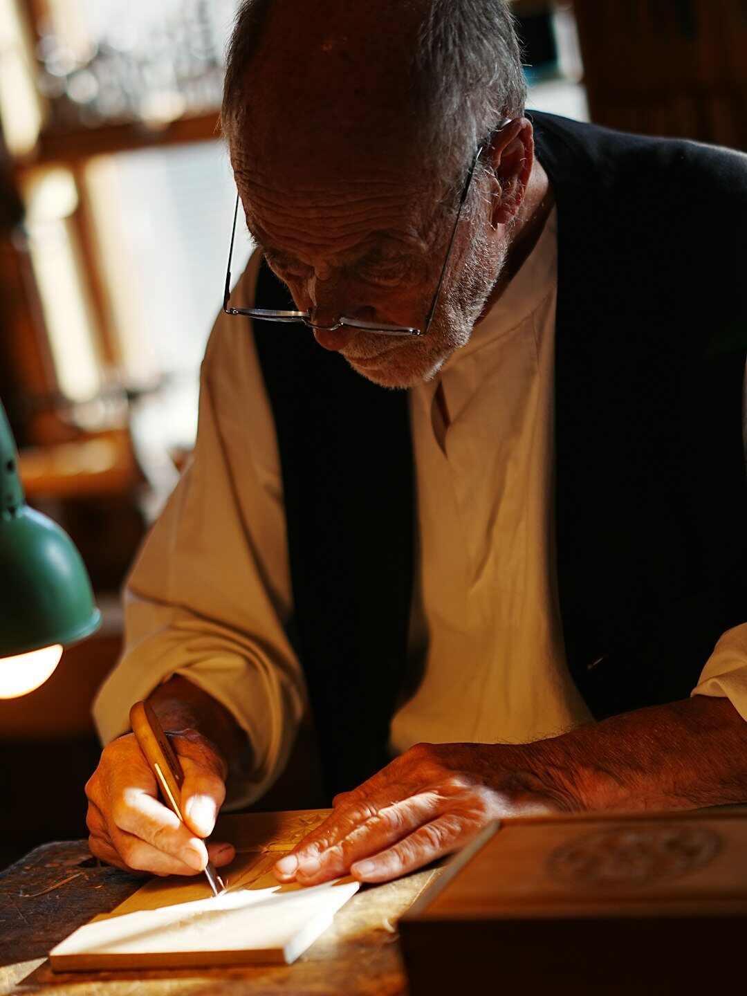 Volunteer helping a senior man with paperwork at a desk