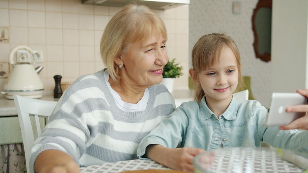 Senior woman smiling while using a tablet at home