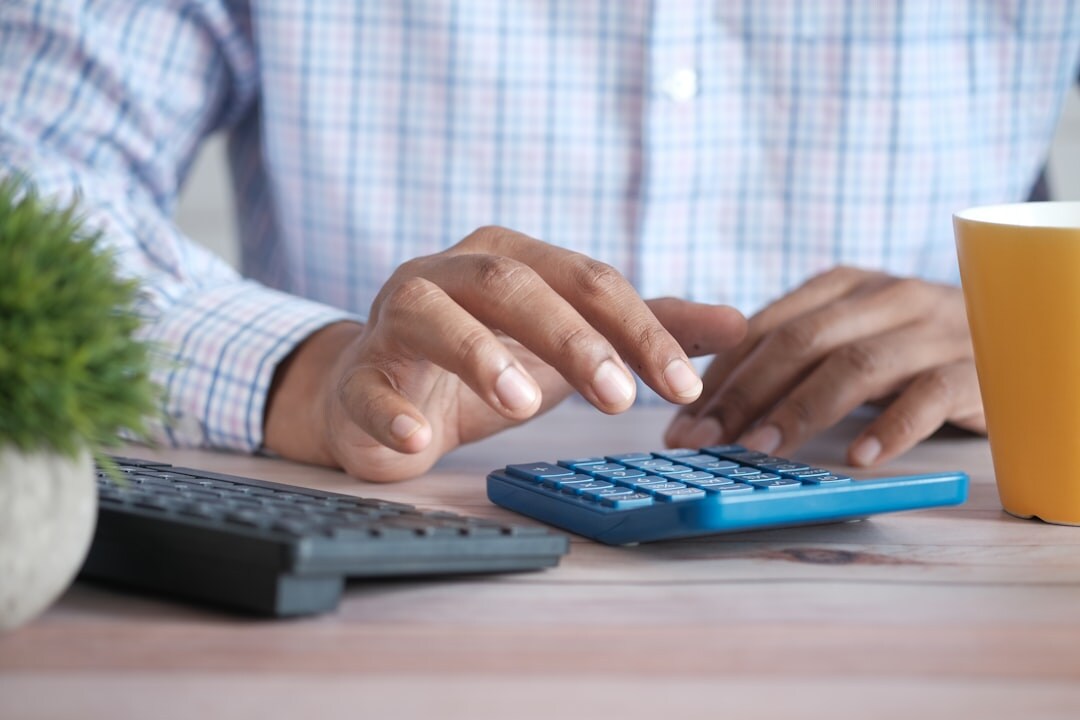 senior using calculator for expenses